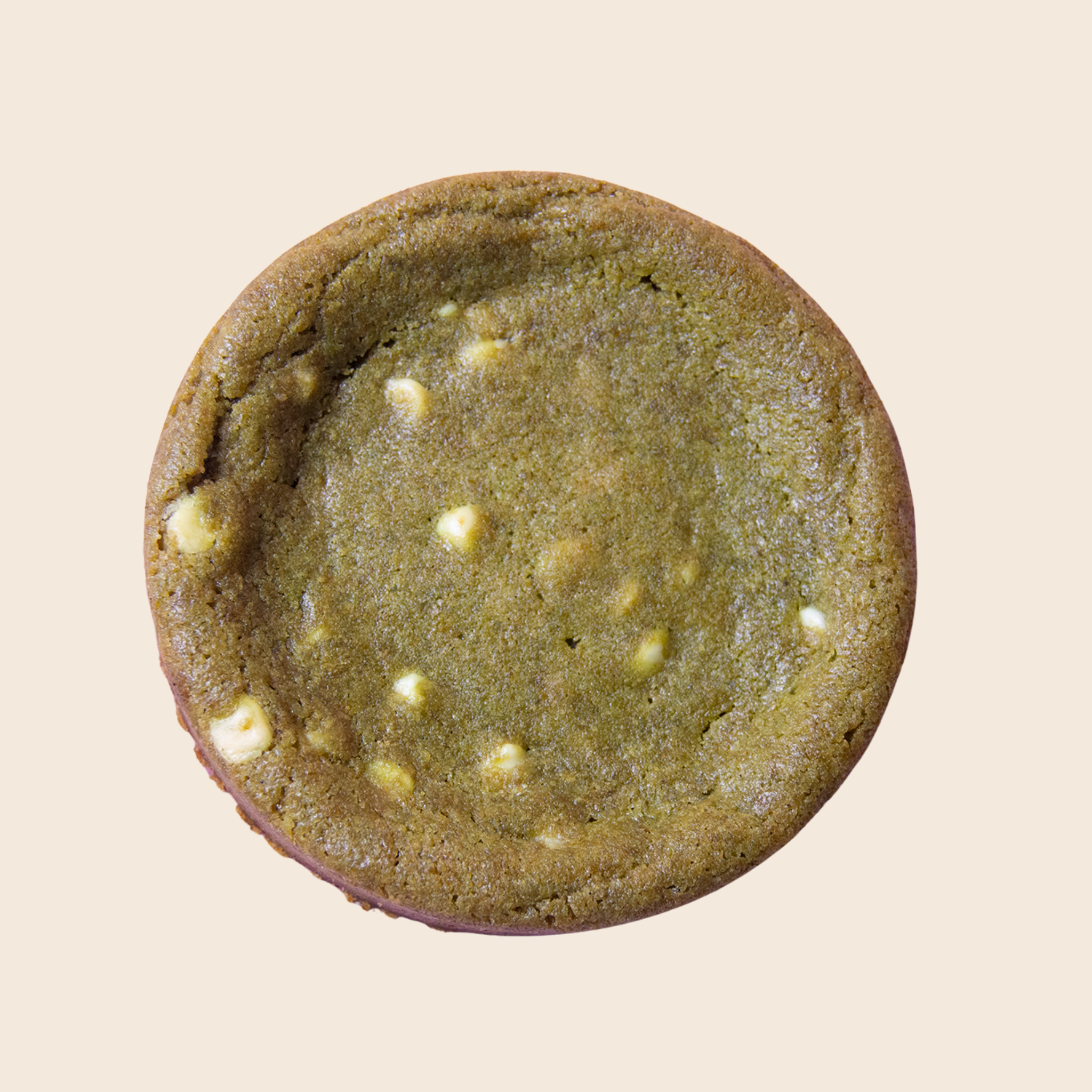 Green Matcha cookie with white  chocolate chips on a beige background